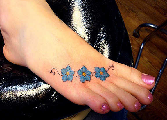 Blue Small Traditional Flower Tattoo On Foot