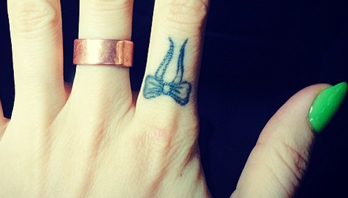 Bow On Left Index Finger Tattoo For Girls