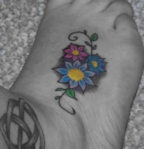 Color Daisy Flowers Tattoo On Right Foot
