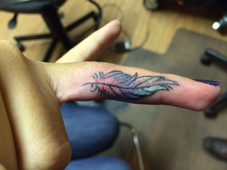 Colored Feather Tattoo On Finger