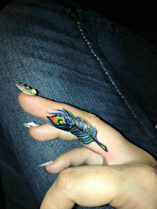 Colored Peacock Feather Tattoo On Side Finger