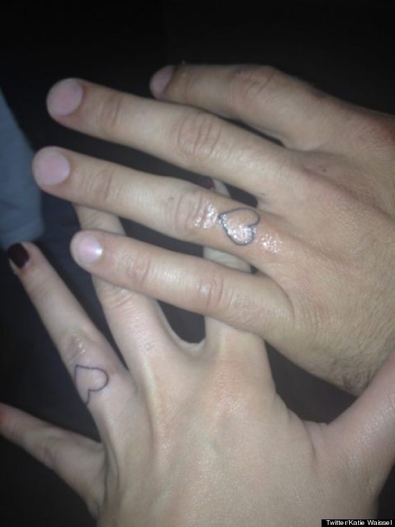 Couple With Outline Finger Heart Tattoos