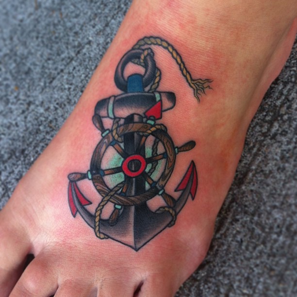 Creative Wheel And Anchor Traditional Tattoo On Foot