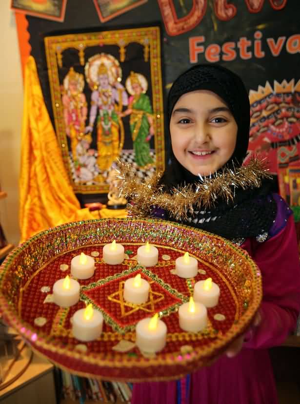 Cute Muslim Girl With Candles Thali During Diwali Celebration