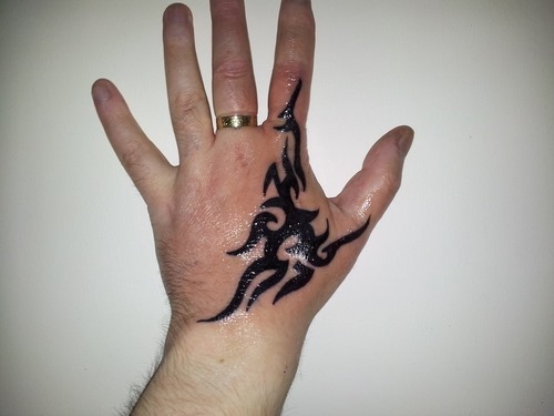 Dark Tribal Design On Hand Tattoo For Men