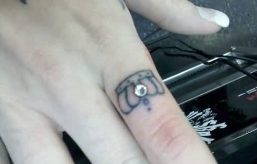 Dermal Piercing And Finger Crown Tattoo