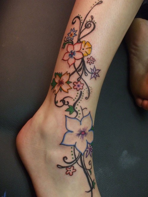 Elegant Color Flower Vine Tattoo On Foot And Leg