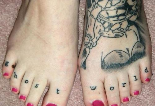 Ghost World Lettering Tattoo On Girl Toe Knuckle
