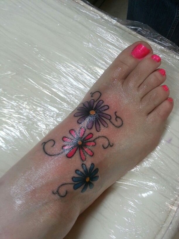 Girl Showing Her Daisy Foot Tattoo