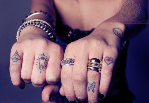 Girl Showing Her Finger Heart Tattoos