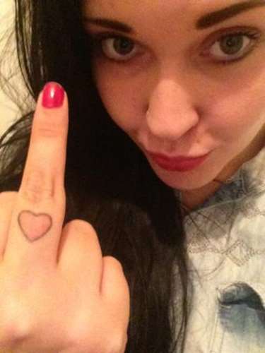 Girl Showing Her Heart Finger Tattoo