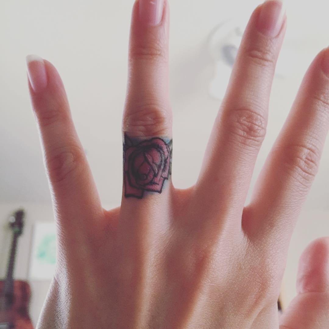 Girl Showing Her Rose Finger Tattoo