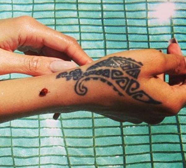 Girl Showing Her Tribal Hand Tattoo