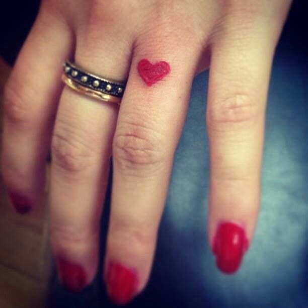 Girl Showing Red Heart Finger Tattoos