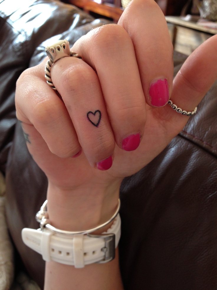 Girl With Cute Heart Finger Tattoo