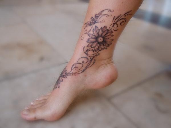 Grey Ink Daisy Tattoo On Right Foot