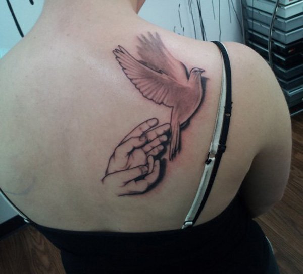 Hands And Flying Dove Tattoo On Upper Back