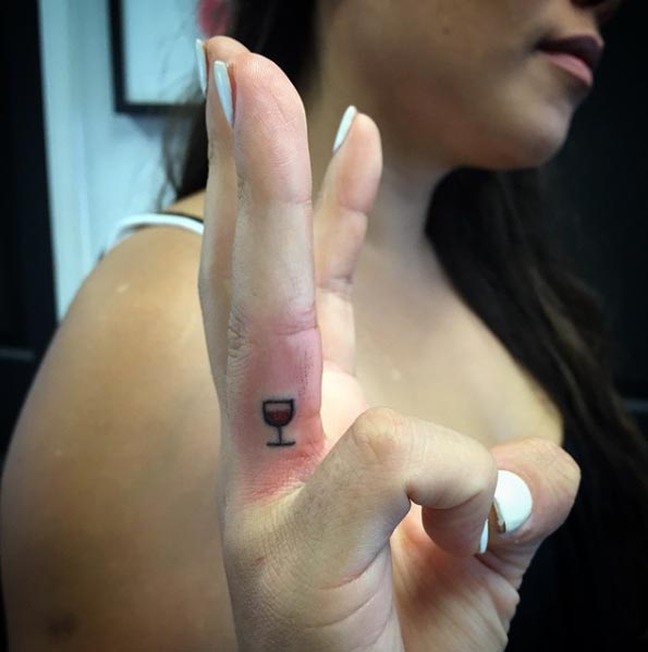 Juice Glass Tattoo On Girl Side Finger