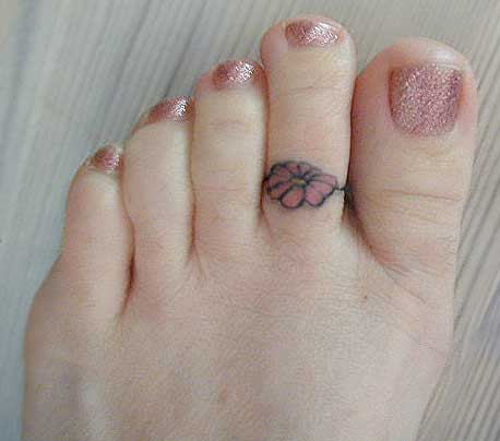 Little Flower Tattoo On Girl Toe