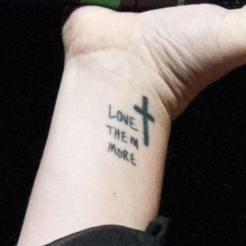 Love Them More Religious Tattoo On Man Wrist
