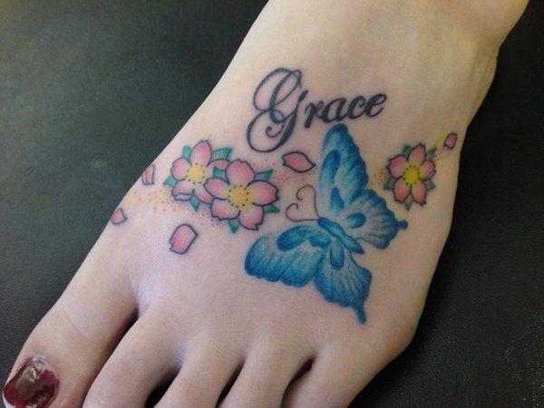 Lovely Remembrance Butterfly And Flowers Tattoo On Foot