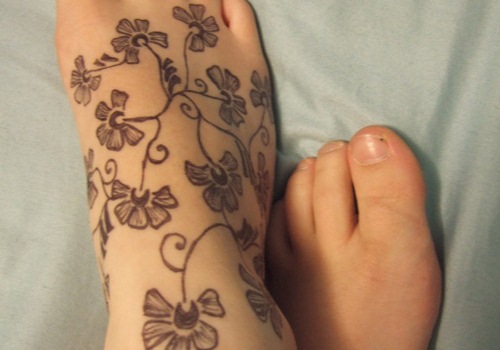 Nice Black And White Foot Flowers Tattoo