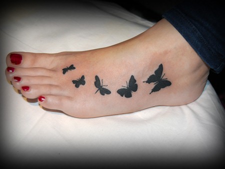 Nice Black Butterflies Silhouette Tattoo On Girl Foot
