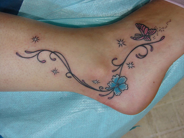 Nice Butterflies With Flowers Stars Tattoo On Ankle And Foot