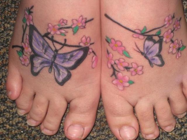 Nice Cherry Blossom Flowers And Butterflies Tattoo On Feet