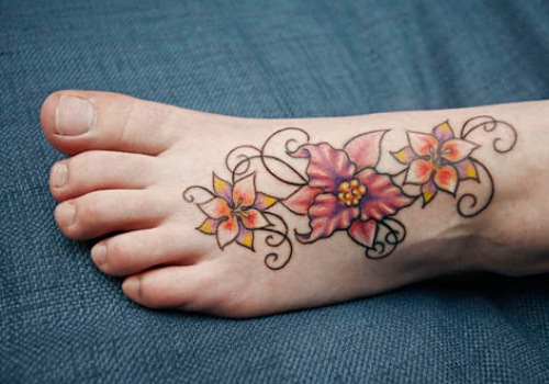 Nice Colorful Flowers Tattoo On Foot