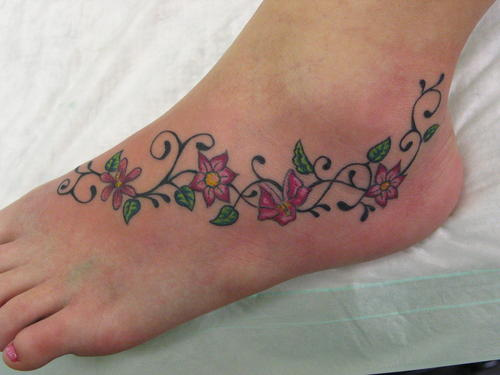 Nice Flower Vine Tattoo On Foot For Girls