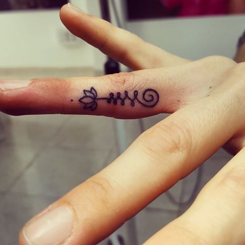 Nice Lotus Flower Tattoo On Side Finger