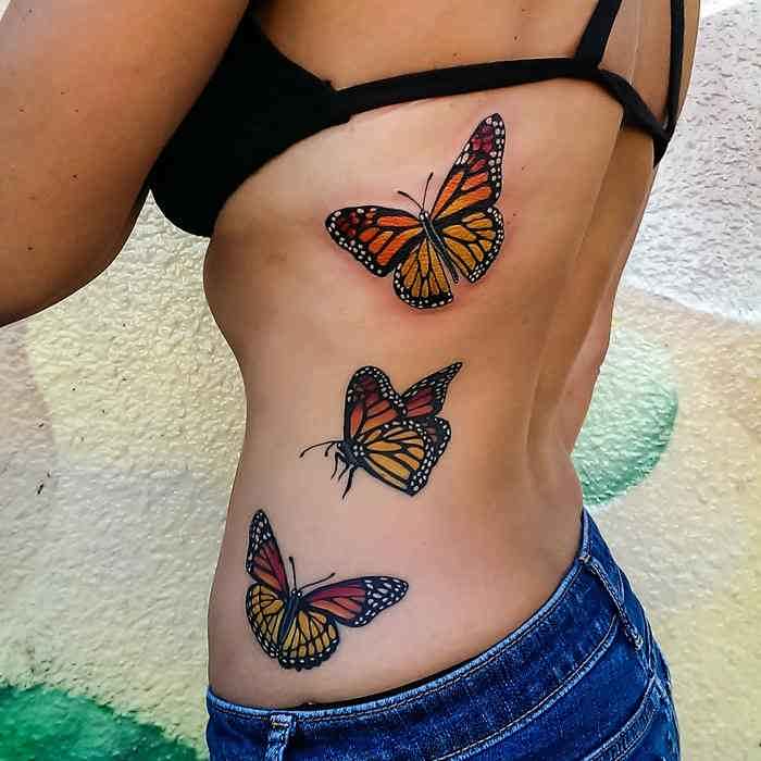 Nice Monarch Butterflies Tattoo On Side Rib For Women