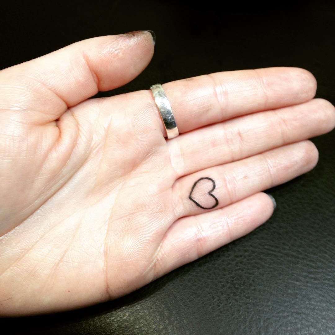 Outline Heart Shape Tattoo On Finger