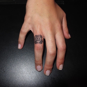 Outline Small Rose Tattoo On Finger