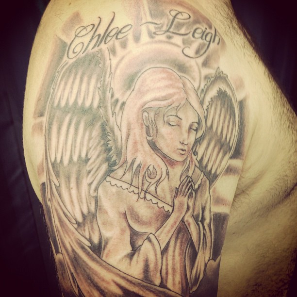 Praying Angel With Lettering Tattoo On Man Shoulder