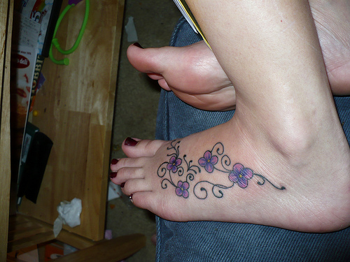 Purple Daisy Flower Tattoo On Girl Left Foot