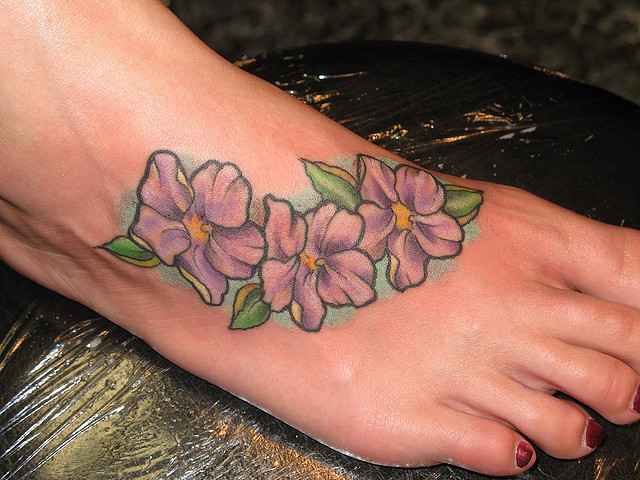 Purple Flowers Tattoo On Foot For Girls