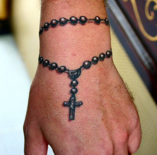 Realistic Black Holy Rosary Tattoo On Hand