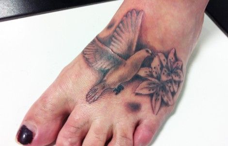Realistic Dove With Flowers Tattoo On Foot