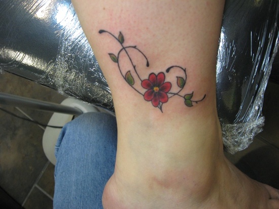 Red Daisy Foot Tattoo On Leg