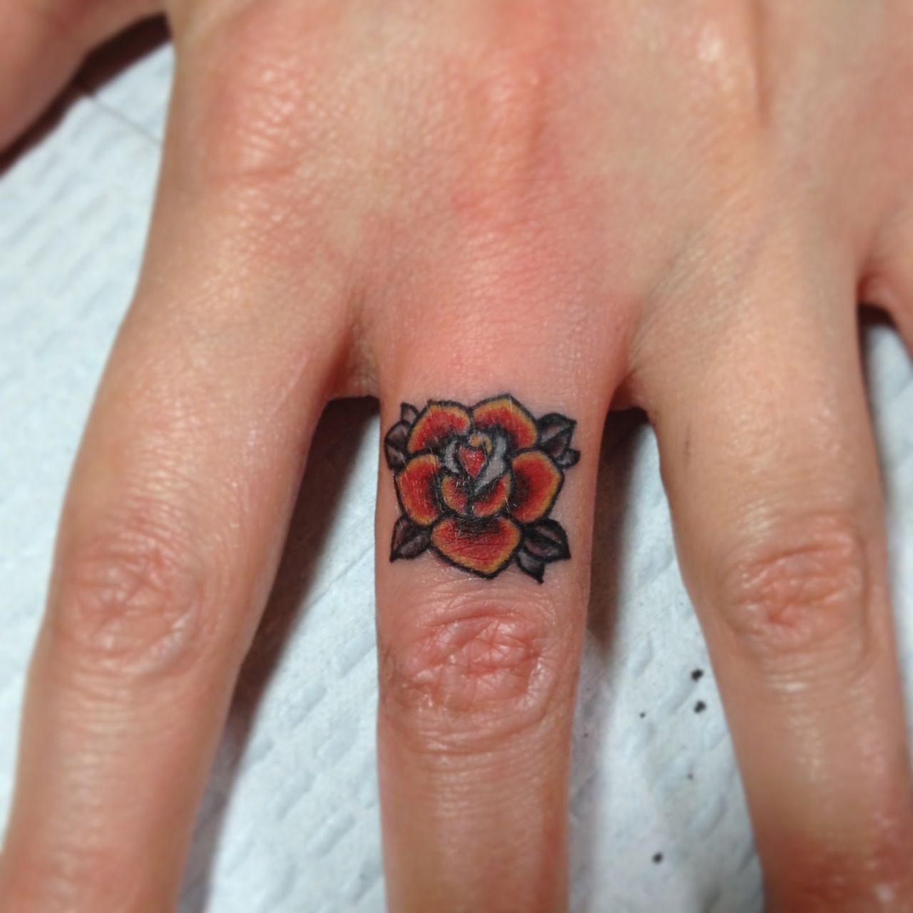 Red Rose Flower Tattoo On Finger