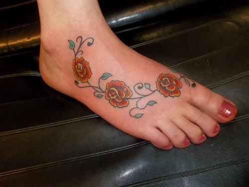Red Roses Traditional Tattoo On Girl Foot