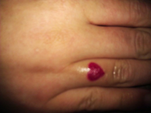 Red Silhouette Heart Tattoo On Finger