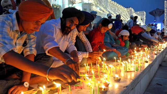 Sikh People Lighting Candles At Golden Temple During Diwali Celebration