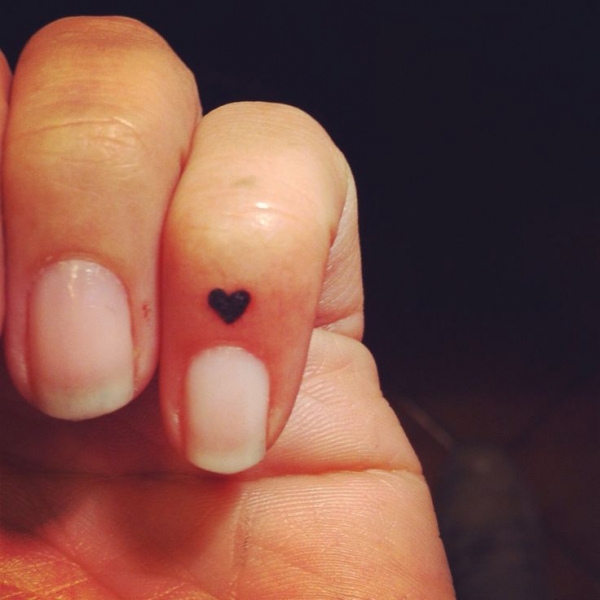 Silhouette Black Heart Tattoo On Finger