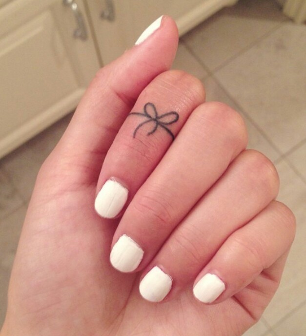 Simple Bow Tattoo On Finger For Girls By Tyler