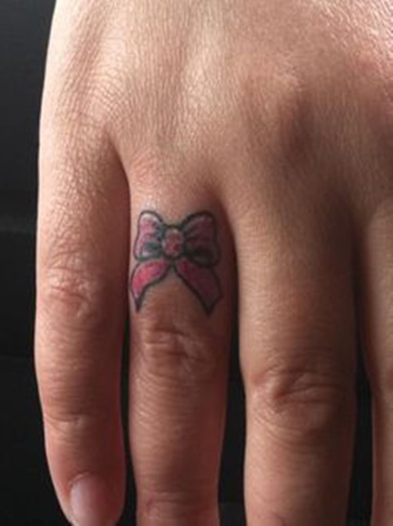Simple Red Bow Tattoo On Finger