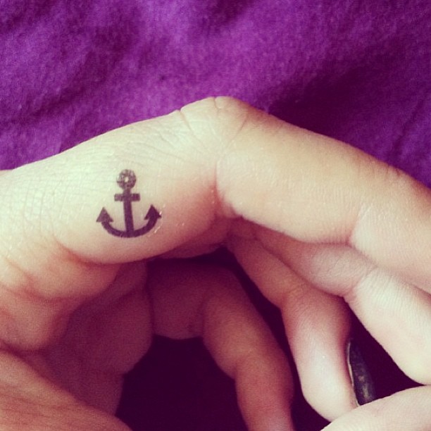 Small Black Anchor Tattoo On Side Finger
