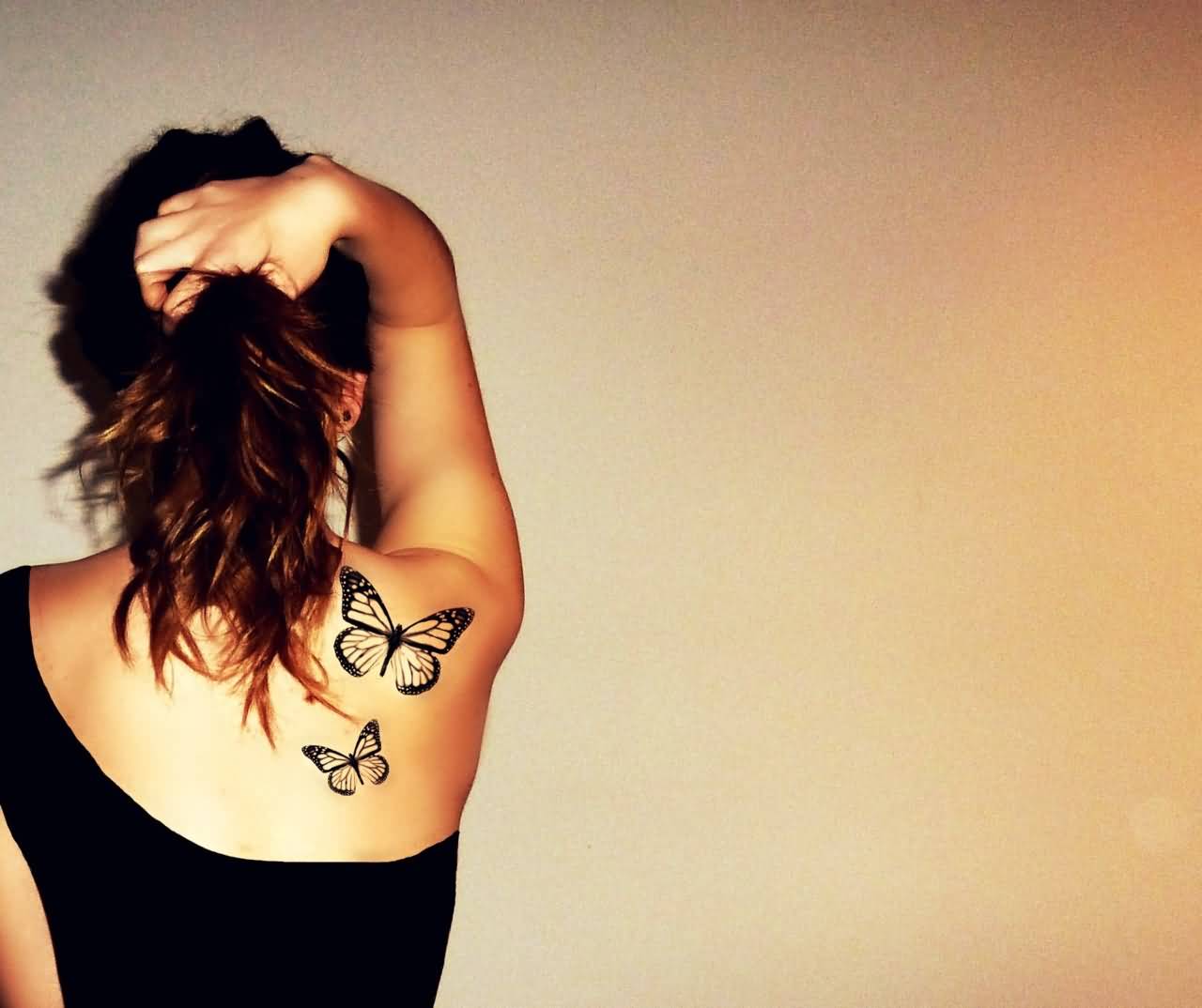 Small Black Butterflies Tattoo On Girl Upper Back